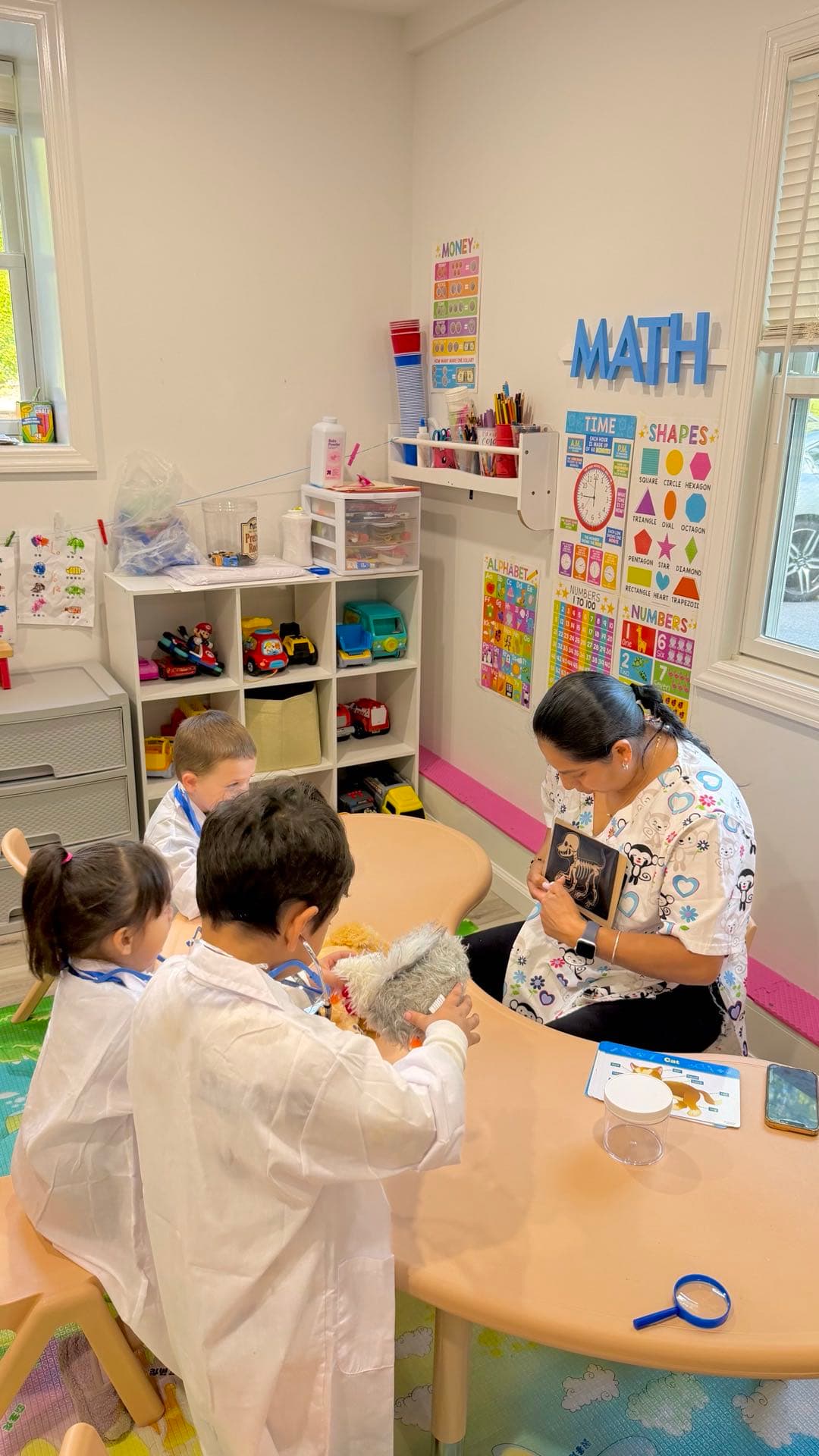 Teacher working with children at a table
